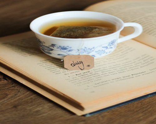 Book and tea cup representing relaxation time